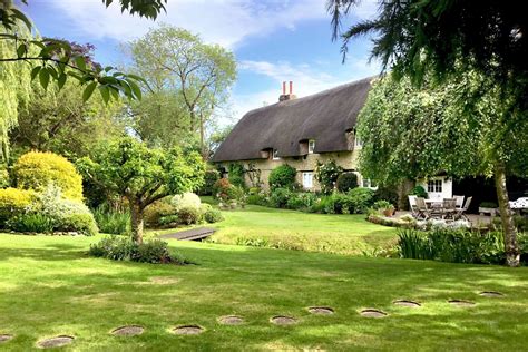 Peek inside this delightful thatched cottage with picture-perfect gardens in Oxfordshire ...