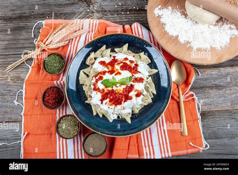 Plates of traditional Turkish food. Turkish Ravioli (Mantı) with yoghurt and tomato sauce Stock ...