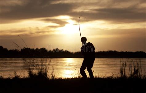 The fisherman at sunset stock photo. Image of dusk, lake - 20535436