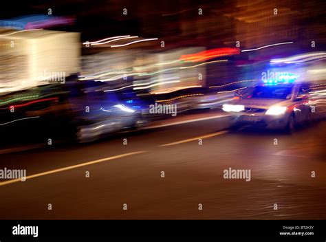 Speeding police car at night, London Stock Photo - Alamy