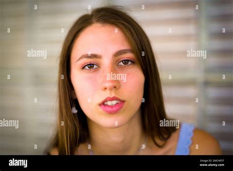 Close up Portrait of Teenage Girl Leaning Against Art Deco Glass Brick Window Stock Photo - Alamy