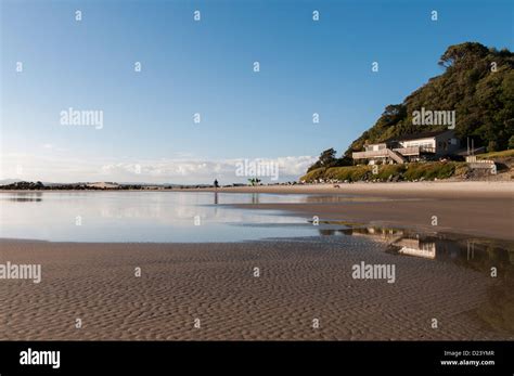 surf walking out to Mangawhai heads surfing break Stock Photo - Alamy