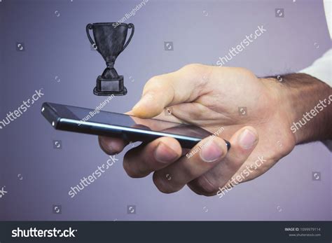 Hand Holding Winner Trophy Stock Photo 1099979114 | Shutterstock