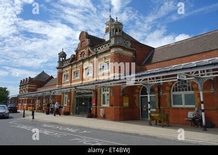 Entrance to Colchester Railway Station Essex glass canopy sliding door flower tubs pots Stock ...