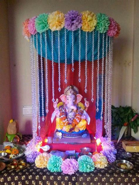 the ganeshi idol is decorated with flowers and beads on display in this ...