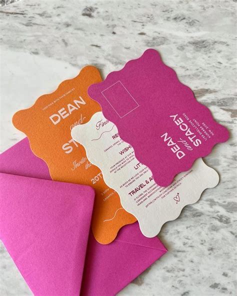 three different colored envelopes sitting next to each other on top of ...