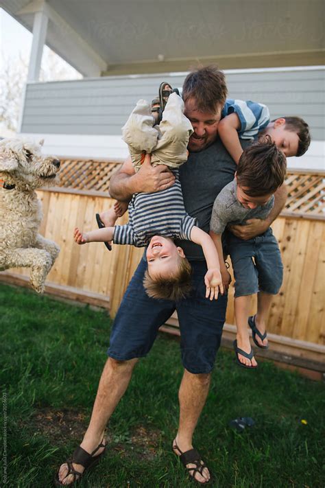 "Dad Playing With Kids In Backyard" by Stocksy Contributor "Rob And ...