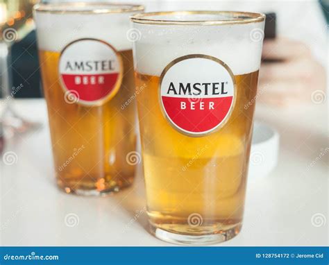 Logo of Amstel Beer on a Glass Sponsored by the Brand. Amstel is a Dutch Light Pilsner Beer ...