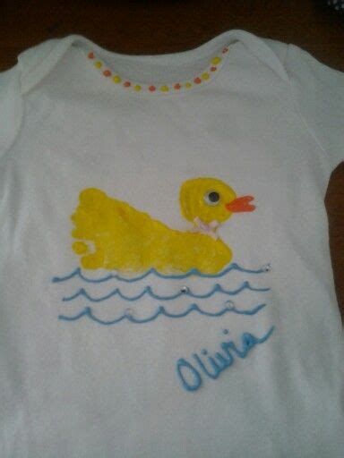 a white shirt with a yellow duck on it