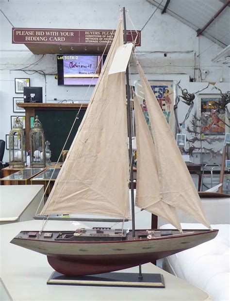 MODEL SAILING YACHT, wooden on base, 73cm L x 98cm H.