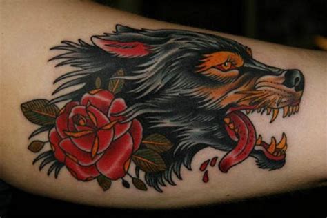 Traditional old style furious bloody wolf and red rose colored tattoo - Tattooimages.biz