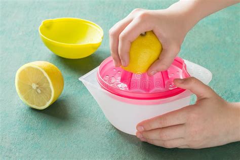 Squeeze Lemon Juice with Handheld Juicer Stock Photo - Image of citrus, health: 105938020