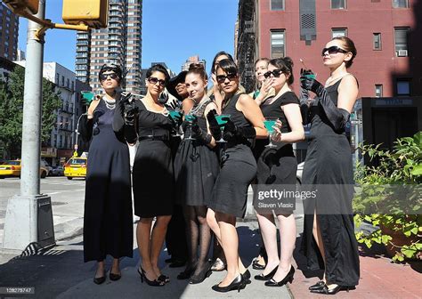 Audrey Hepburn look-alikes in black party dresses with cigarette... News Photo - Getty Images