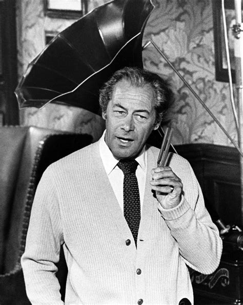 Rex Harrison holds up one of his tuning forks as Professor Henry Higgins in MY FAIR LADY. My ...