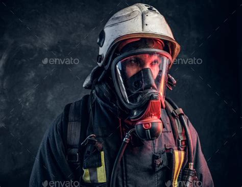 Close-up portrait of a firefighter in safety helmet and oxygen mask ...