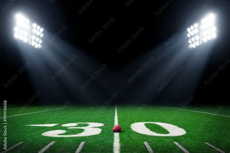 Football field at night with stadium lights Stock Photo | Adobe Stock