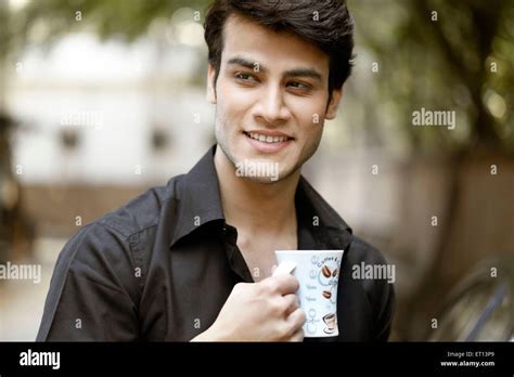 Man Holding Coffee Mug India Asia MR#790E Stock Photo - Alamy