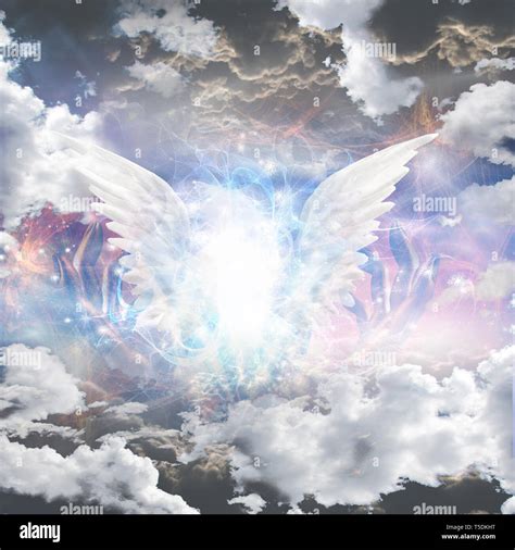 Angel of light. Glowing white wings in clouds Stock Photo - Alamy