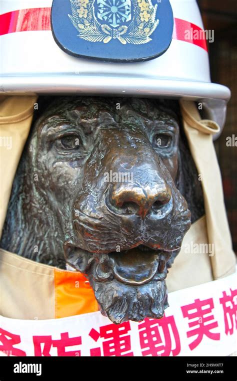 One of the bronze lion statues location at the main entrance to Mitsukoshi Department Store in ...