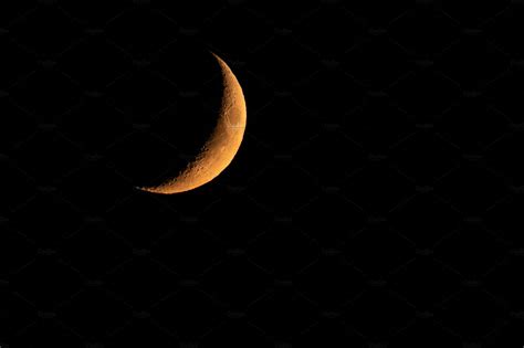 Yellow crescent moon in the dark | Nature Stock Photos ~ Creative Market