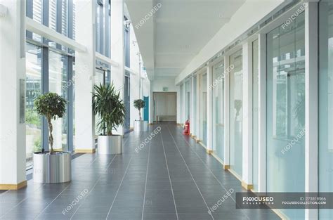 Corridor in modern office building with glass walls — inside, work ...