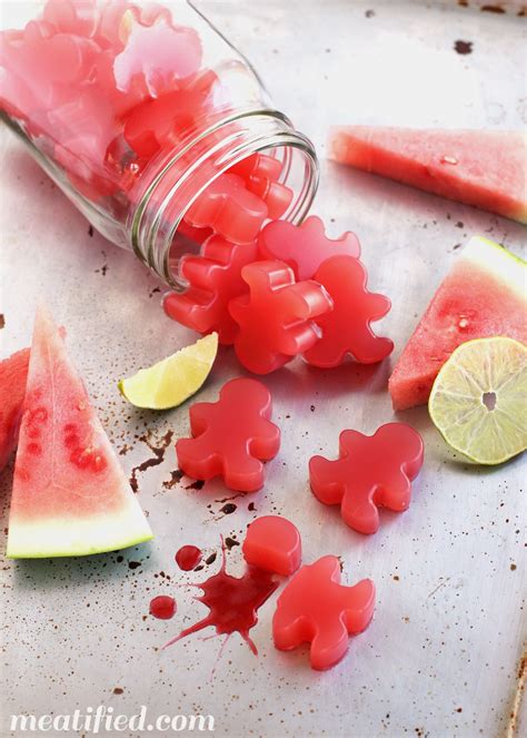 watermelon slices, limes and lemon wedges are scattered around a mason ...