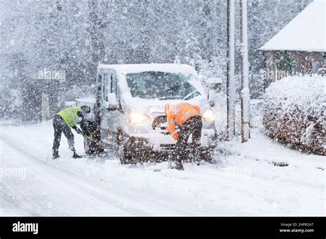 Clearing snow away from stuck vehicle hi-res stock photography and ...