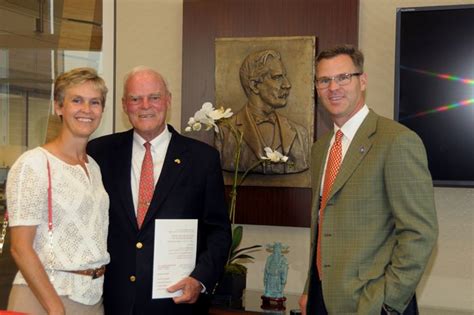 The Eccles Family in the First Security Boardroom with David Eccles' portrait on the wall. The ...