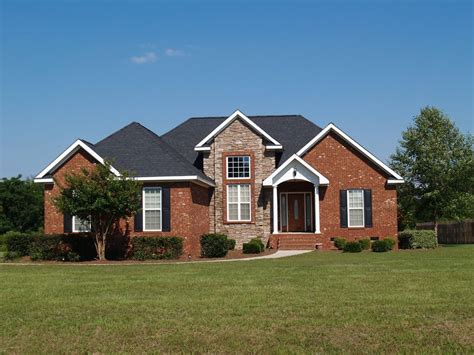 Suburban home with red brick and stone facade. Brick And Stone House Exterior, Red Brick ...