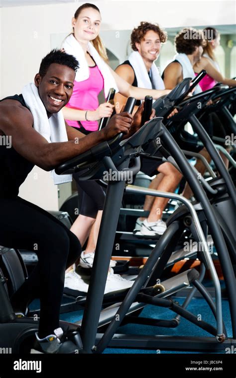 Young group of friends working out together in a gym Stock Photo - Alamy