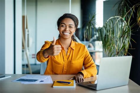 Premium Photo | Happy african american female office manager sitting at ...