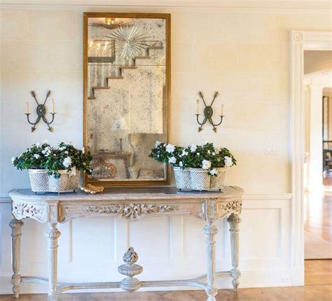 The sideboard is an antique, the planters are Niermann Weeks, mirror is John Rosselli, sconces ...