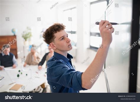 Young Teacher Writing On Whiteboard During Stock Photo 2190204319 | Shutterstock