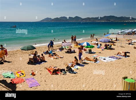 People sunbathing on the beach at Cannes, France Stock Photo - Alamy