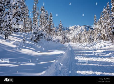 Winter in Idaho with snow covered road and mountains Stock Photo - Alamy