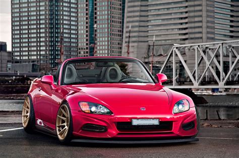 Red Honda S2000 convertible parked on gray concrete road near white ...