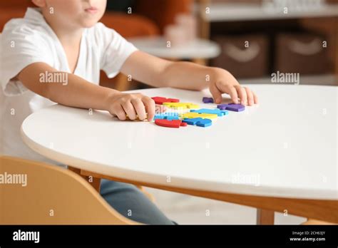 Little boy with autistic disorder doing puzzle at home Stock Photo - Alamy