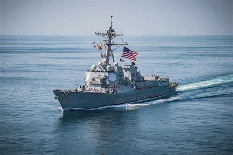 USS Jason Dunham flies the battle ensign and the flag of France. - a ...