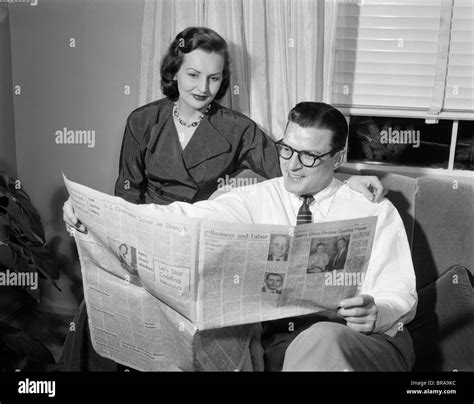 Man reading newspaper while sitting Black and White Stock Photos & Images - Alamy