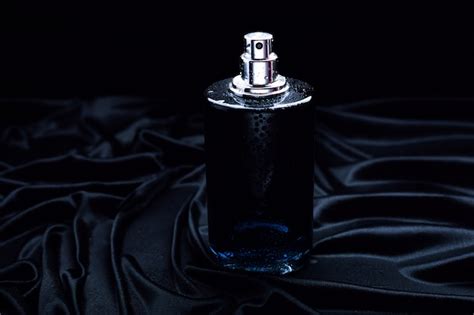 Premium Photo | Black perfume on a black fabric background