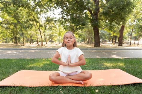 Free Photo | Full shot girl meditating on yoga mat