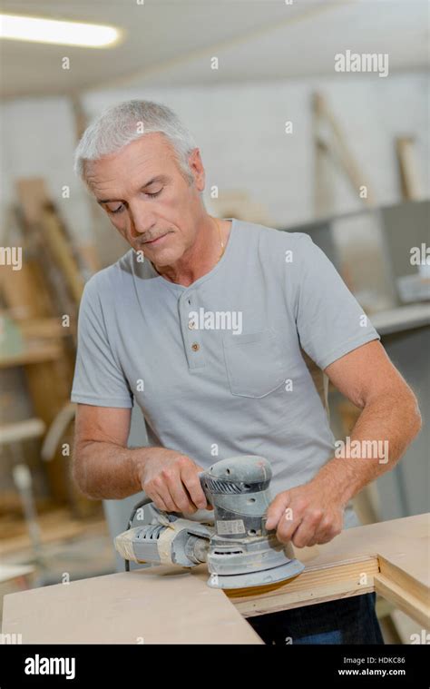 Man using circular sander Stock Photo - Alamy