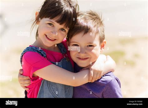 two happy kids hugging outdoors Stock Photo - Alamy