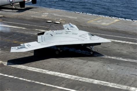 A U.S. Navy X-47B Unmanned Combat Air System makes an arrested landing ...