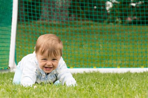 Little Boy Playing on the Football Field with Gates Stock Photo - Image ...