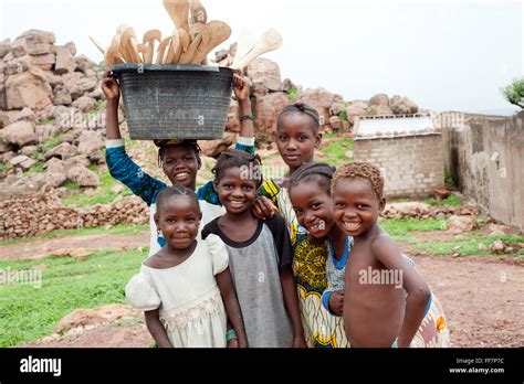 Mali, Africa - Young people carrying food, cereals in a village near ...