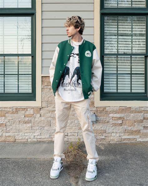 Man wearing Green varsity jacket outfit with Jordan 4s seafoam at a ...