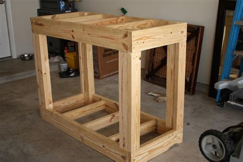 a wooden table sitting in the middle of a room with tools and other ...