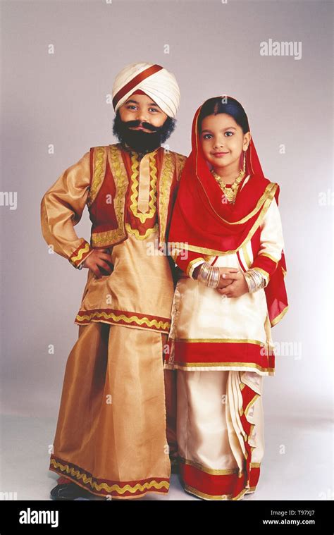 YOUNG BOY AND GIRL DRESSED AS A SIKH COUPLE IN TRADITIONAL COSTUME. BOY ...