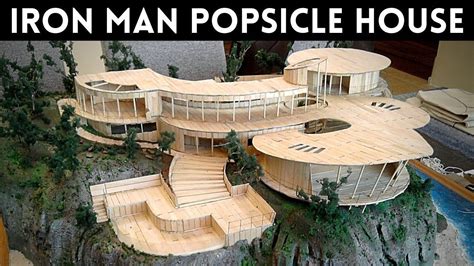 a model of an iron man popsicle house with trees and rocks in the ...